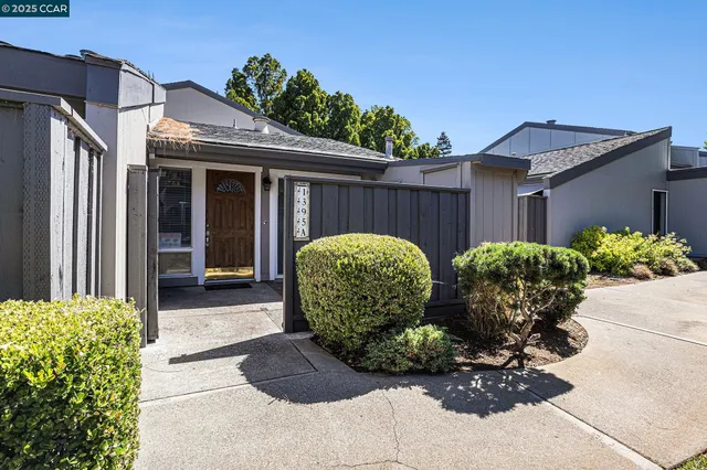 a view of a house with bunch of flower plants