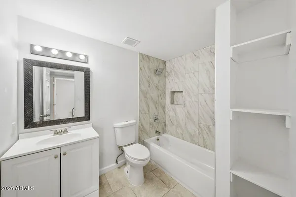 a bathroom with a toilet a sink and a bathtub