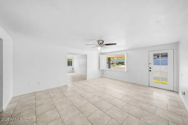an empty room with windows and cabinet