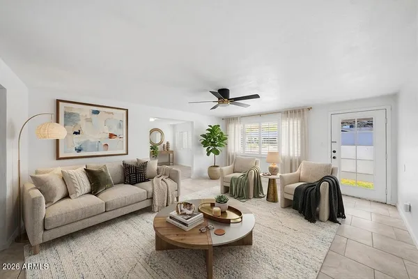 a living room with furniture a rug and a table