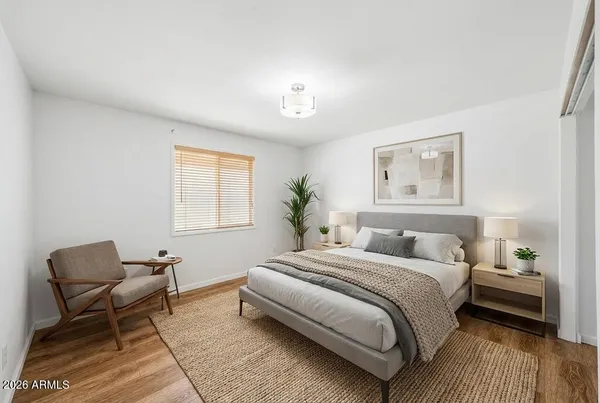 a bedroom with a bed and a couch