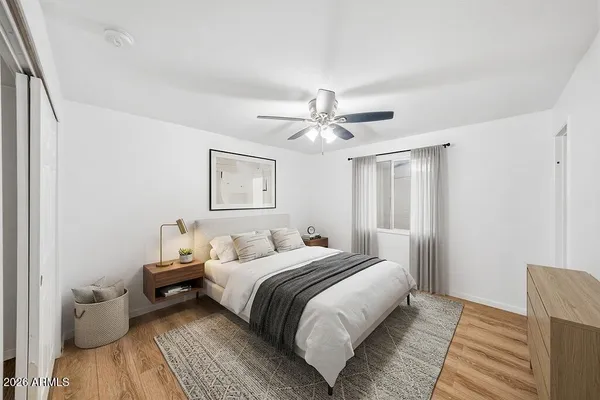 a bedroom with a bed and a chandelier