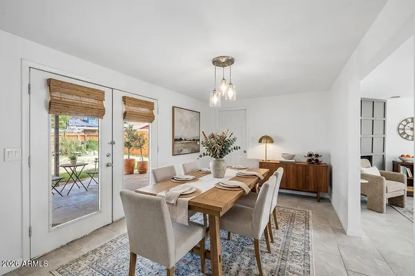 a dining room with furniture a rug and a chandelier