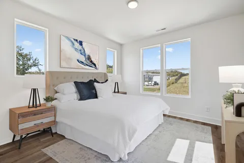 a bedroom with a bed and a painting on the wall