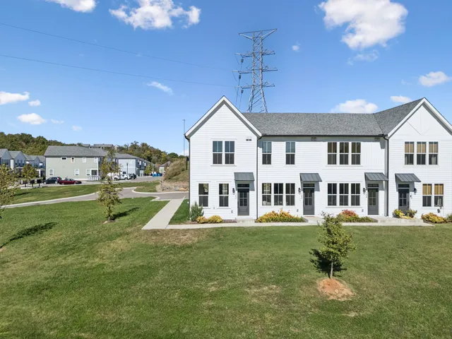 a front view of a house with a yard table and chairs
