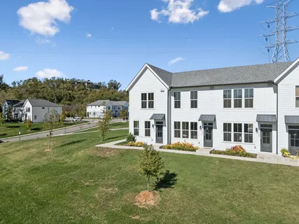 a view of a house with backyard porch and sitting area