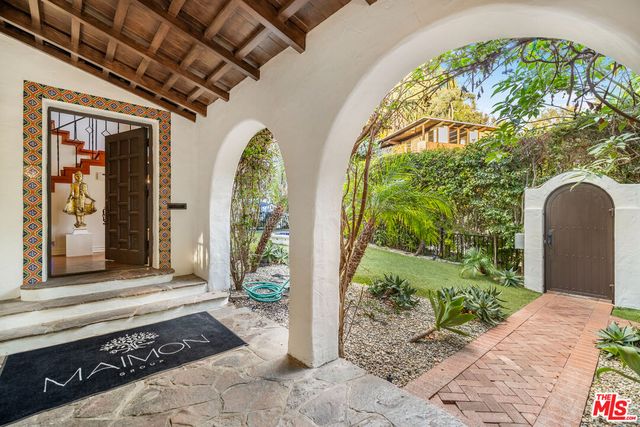 a living room with patio furniture and a large window