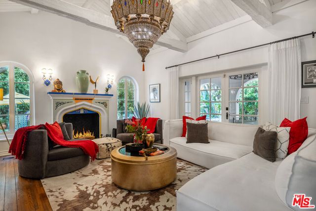 a living room with lots of furniture and a chandelier