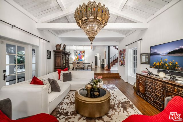 a living room with furniture chandelier and a chandelier