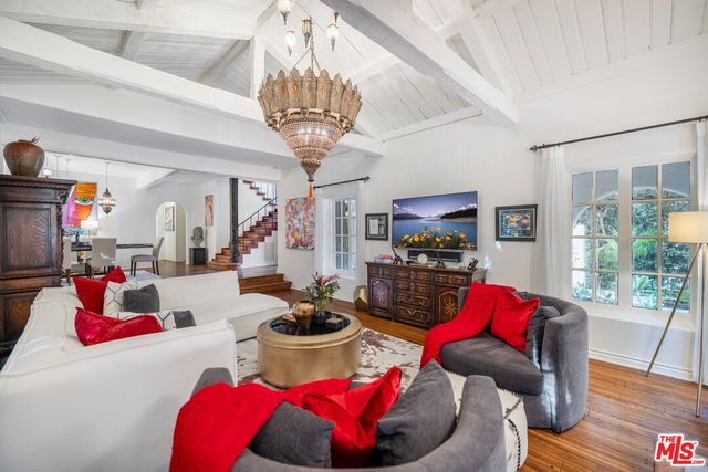 a view of a dining room with furniture wooden floor and chandelier