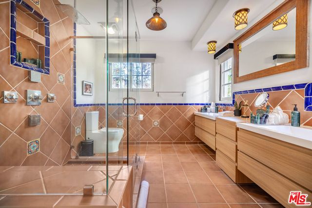 a room with a washing machine and a mirror