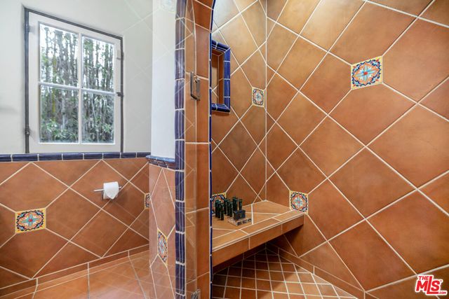 a bedroom with a bed and large window