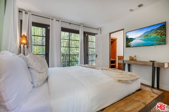 a bedroom with a bed and a chandelier