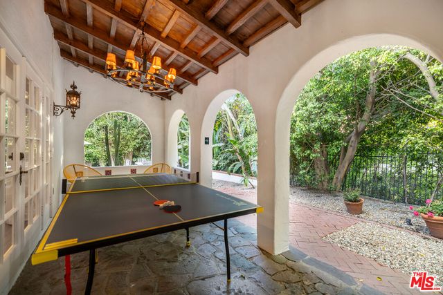 a backyard of a house with barbeque oven table and chairs