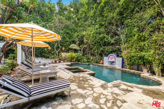 a view of a patio with table and chairs under an umbrella