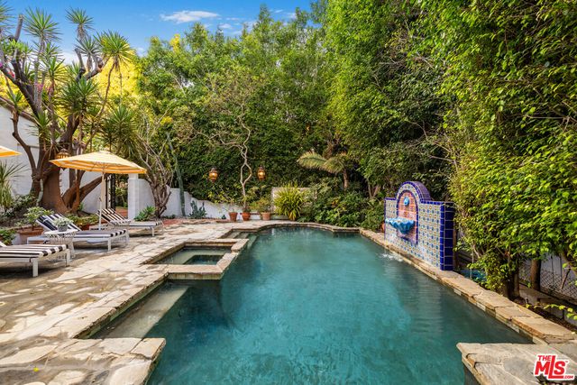 swimming pool view with a seating space