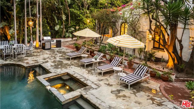 a view of a backyard with swimming pool