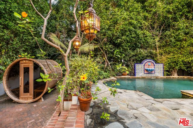 a view of swimming pool with yard and outdoor seating
