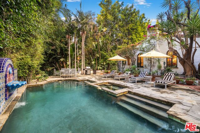 a swimming pool with outdoor seating and yard
