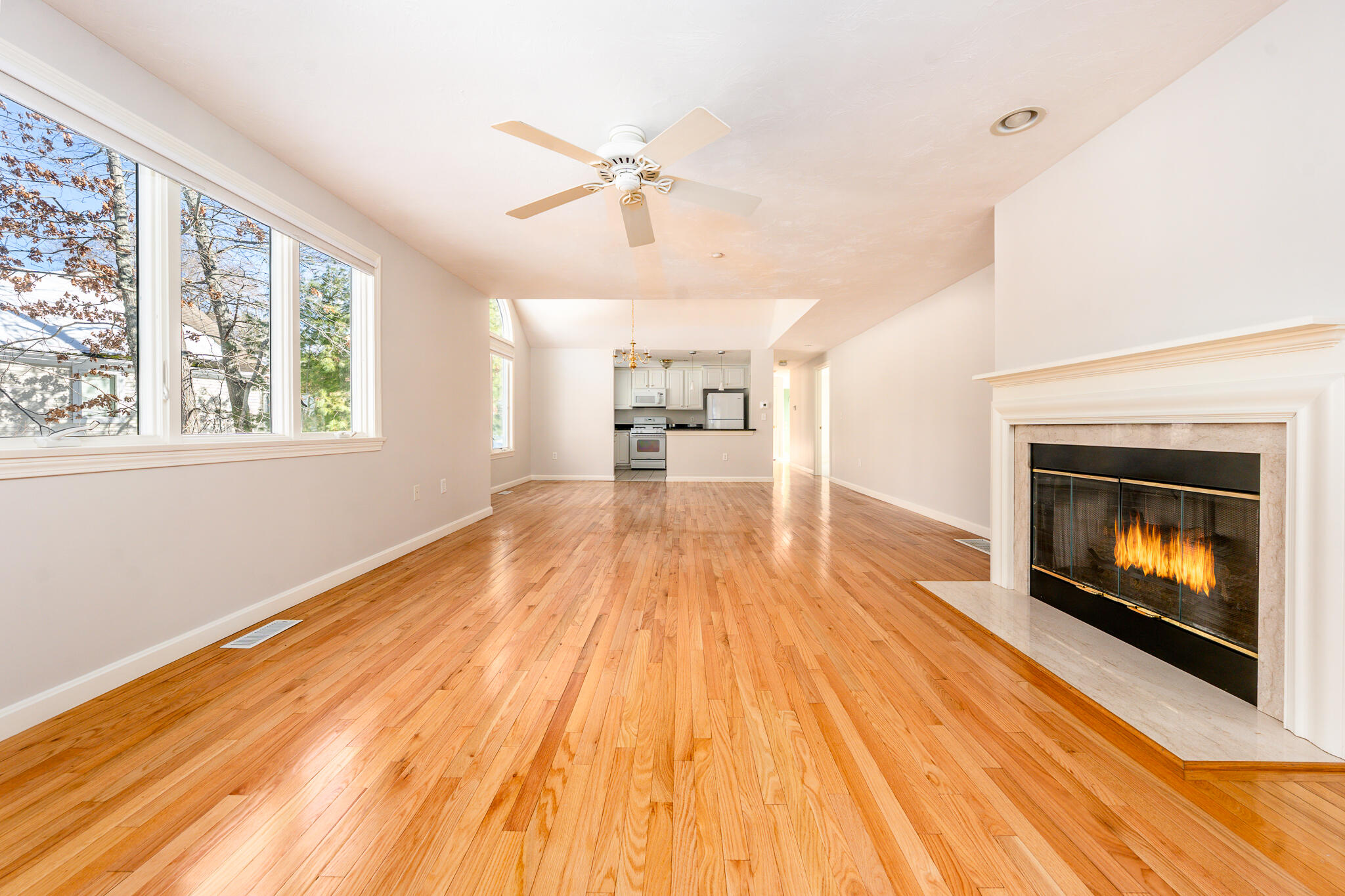 13 Pga Lane Mashpee, MA 02649 - Photo 2 of 28 a view of an empty room with wooden floor fireplace and a window