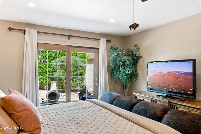 a bedroom with a bed and a large window