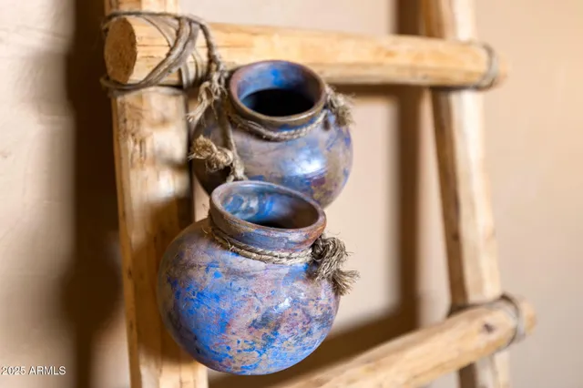 a living room with furniture a rug and white walls