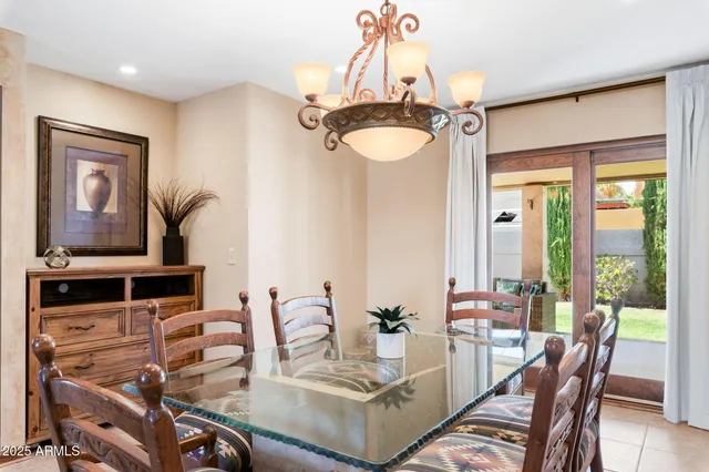 a spacious bedroom with a bed and a chandelier