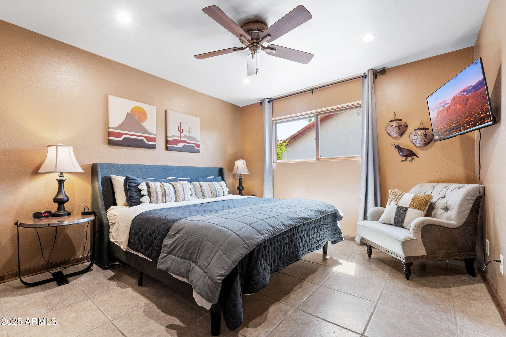 9972 East Del Monte Avenue Gold Canyon, AZ 85118 - Photo 35 of 49 a spacious bedroom with a bed and a chandelier