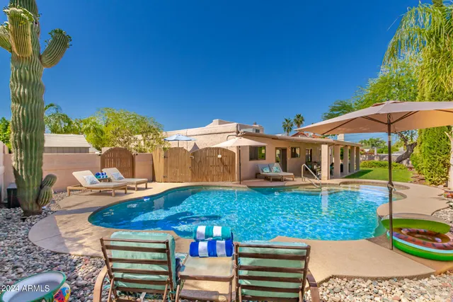 a view of a swimming pool with a lounge chairs