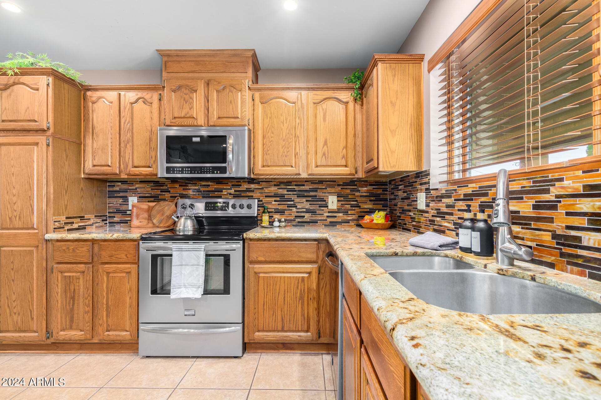 9972 East Del Monte Avenue Gold Canyon, AZ 85118 - Photo 4 of 49 a kitchen with kitchen island granite countertop a sink a counter top space appliances and cabinets