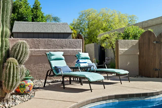 a outdoor living space with furniture potted plant and a large window