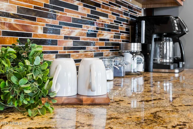 a kitchen with stainless steel appliances granite countertop a refrigerator a stove top oven a sink and dishwasher