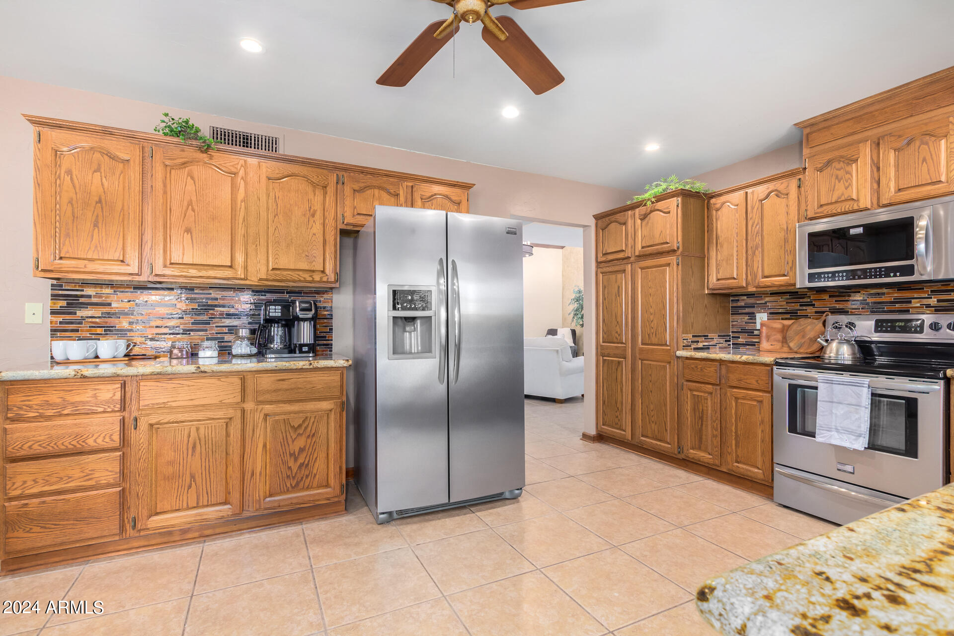 9972 East Del Monte Avenue Gold Canyon, AZ 85118 - Photo 9 of 49 a kitchen with stainless steel appliances granite countertop a refrigerator a stove top oven a sink and dishwasher