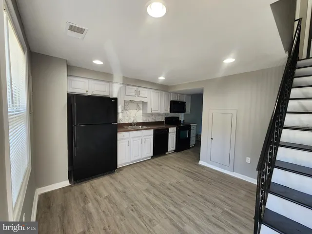 a kitchen with a refrigerator a sink and a stove