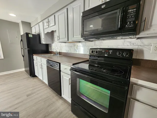 a kitchen with a stove and a microwave