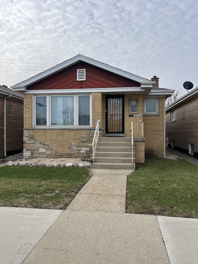 4505 West 55th Street Chicago, IL 60632 - Photo 2 of 15 a front view of a house with a yard