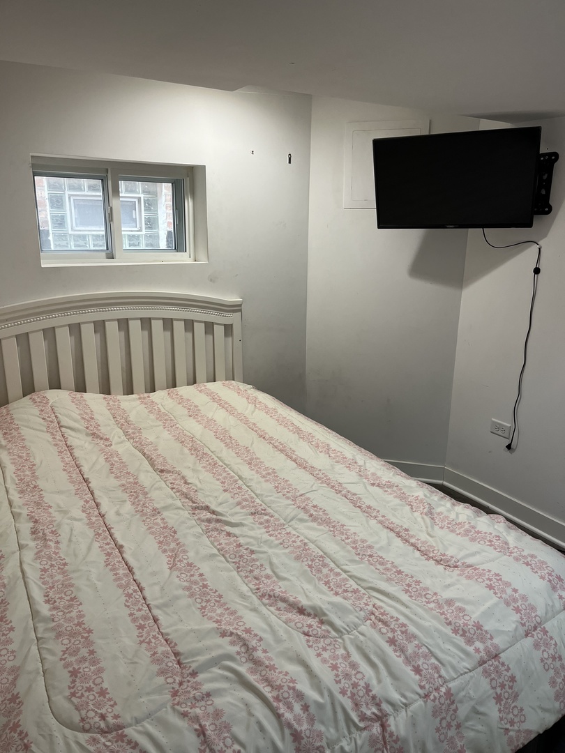 4505 West 55th Street Chicago, IL 60632 - Photo 7 of 15 a bed sitting in a bedroom next to a window