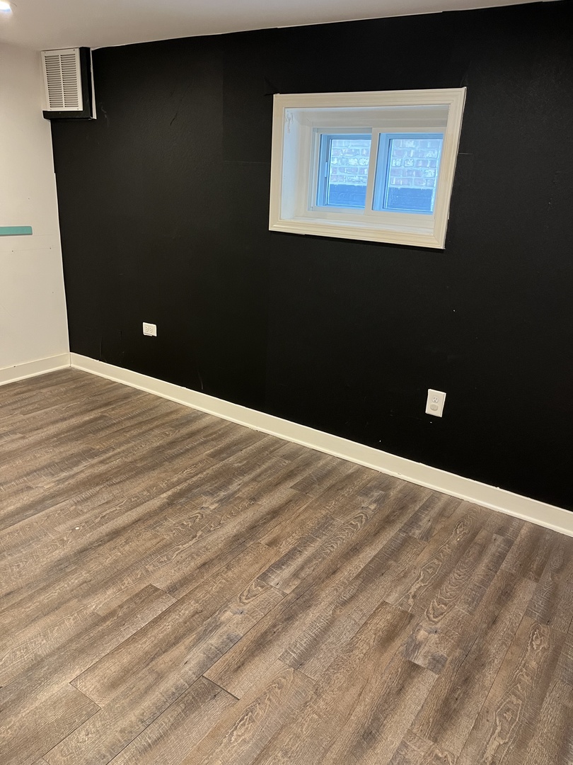 4505 West 55th Street Chicago, IL 60632 - Photo 8 of 15 a view of an empty room with wooden floor