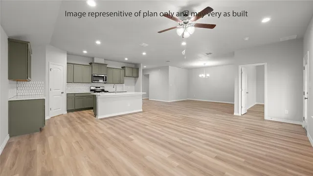 a view of a kitchen with a sink and a refrigerator
