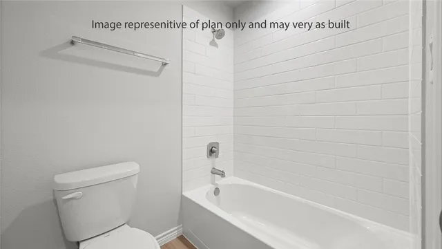a bathroom with a toilet and bathtub