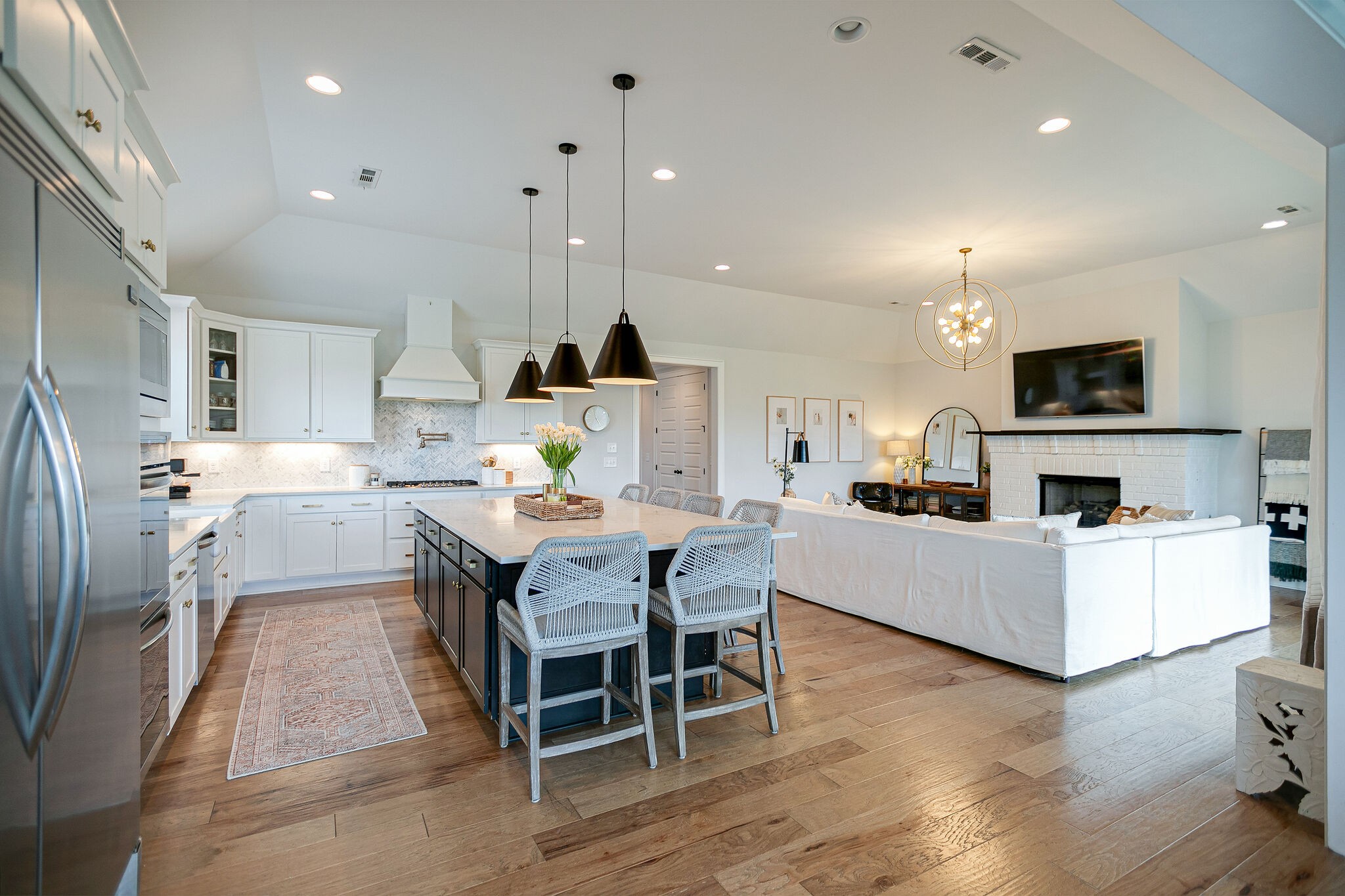 6563 Windmill Drive College Grove, TN 37046 - Photo 17 of 40 a kitchen with stainless steel appliances a dining table chairs microwave and sink