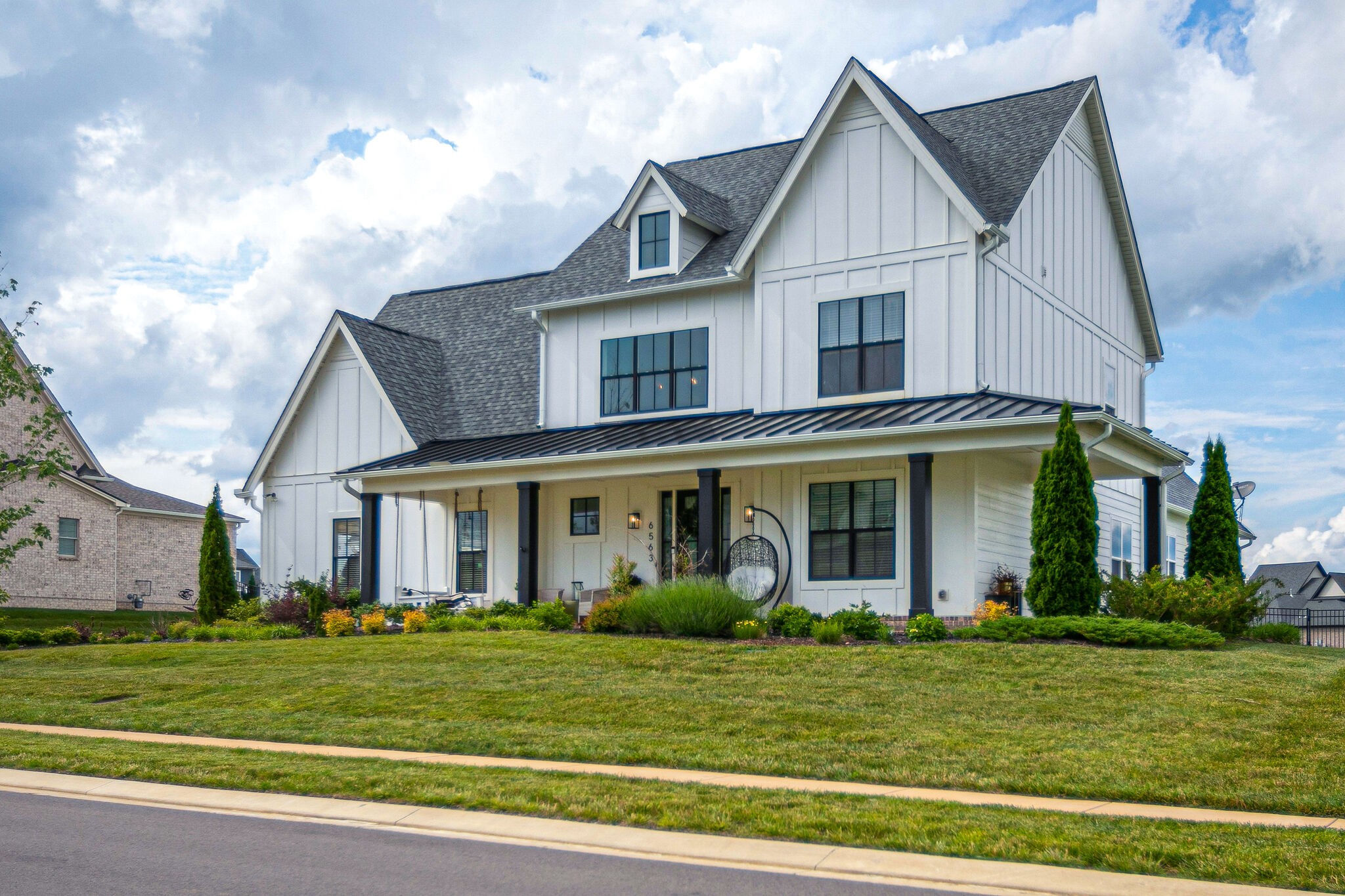 6563 Windmill Drive College Grove, TN 37046 - Photo 2 of 40 a front view of a house with a garden