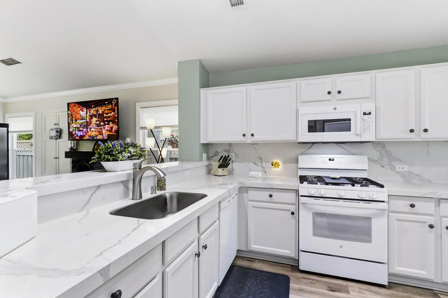 5297 Angelrock Loop Roseville, CA 95747 - Photo 13 of 33 a kitchen with white cabinets and white appliances