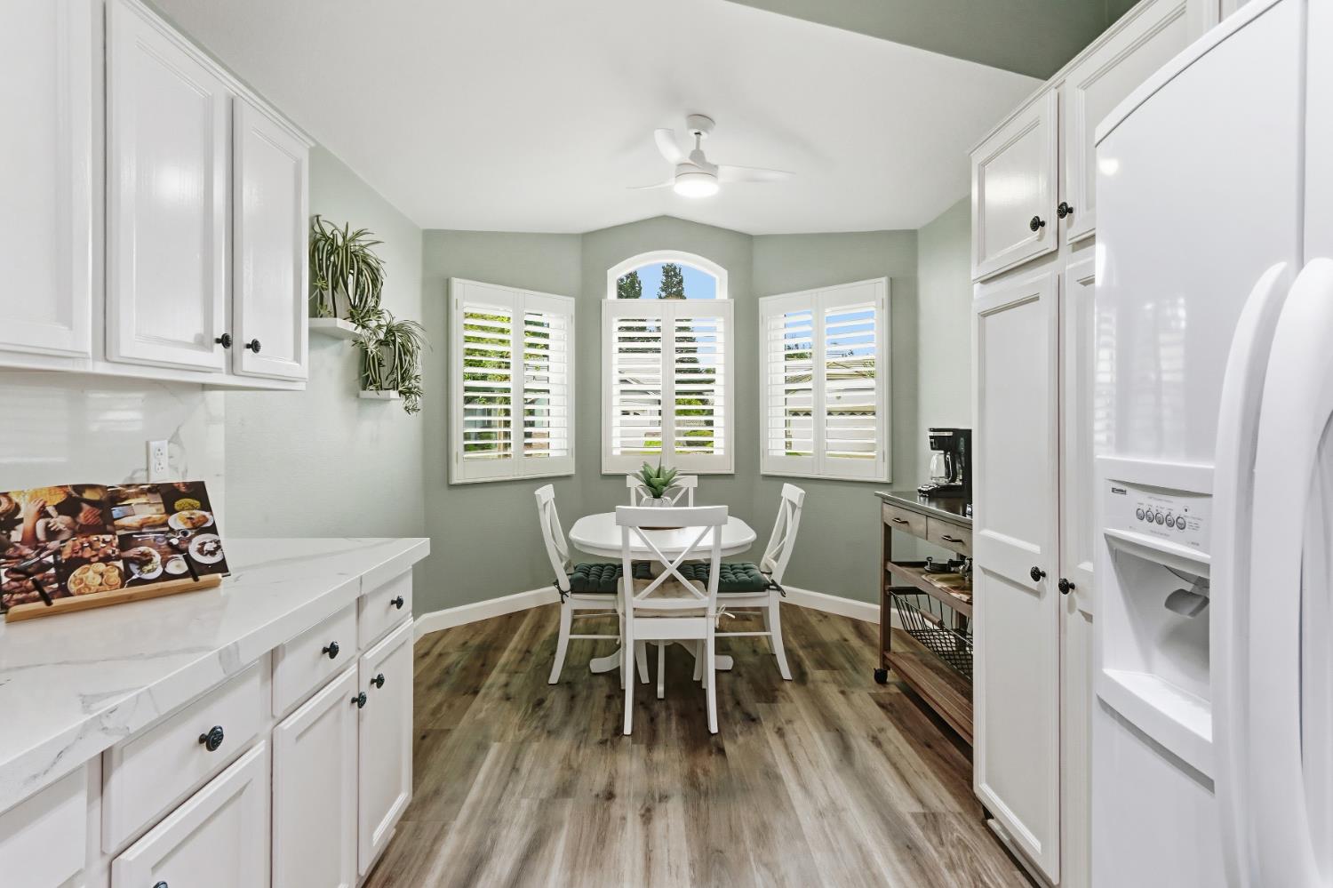 5297 Angelrock Loop Roseville, CA 95747 - Photo 15 of 33 a kitchen with stainless steel appliances a dining table chairs and chandelier