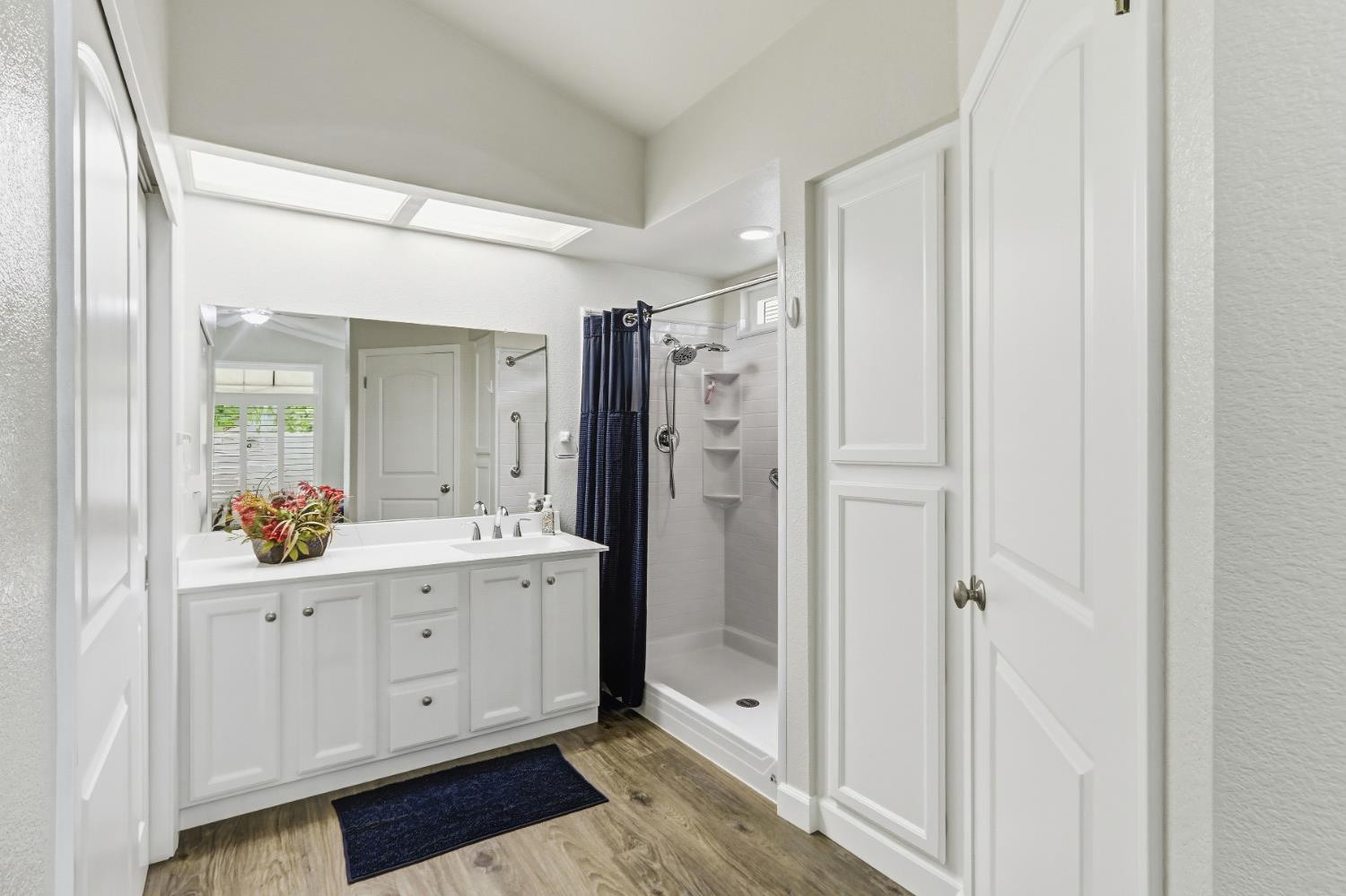 5297 Angelrock Loop Roseville, CA 95747 - Photo 21 of 33 a view of bathroom with a shower a sink and a mirror