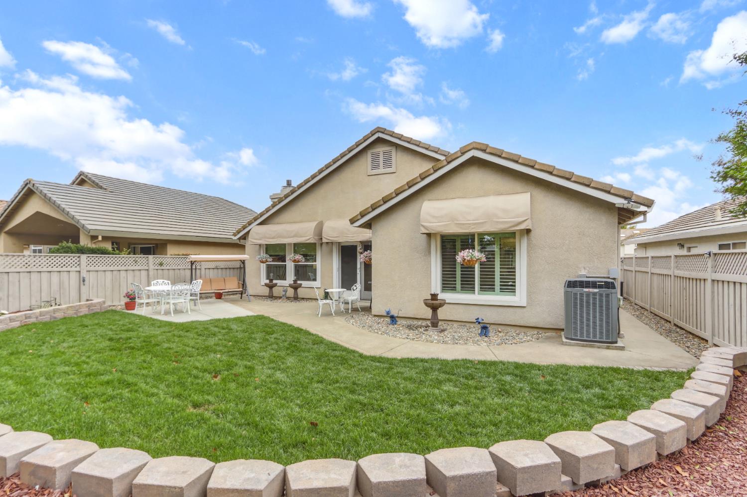 5297 Angelrock Loop Roseville, CA 95747 - Photo 29 of 33 a front view of house with a garden and patio