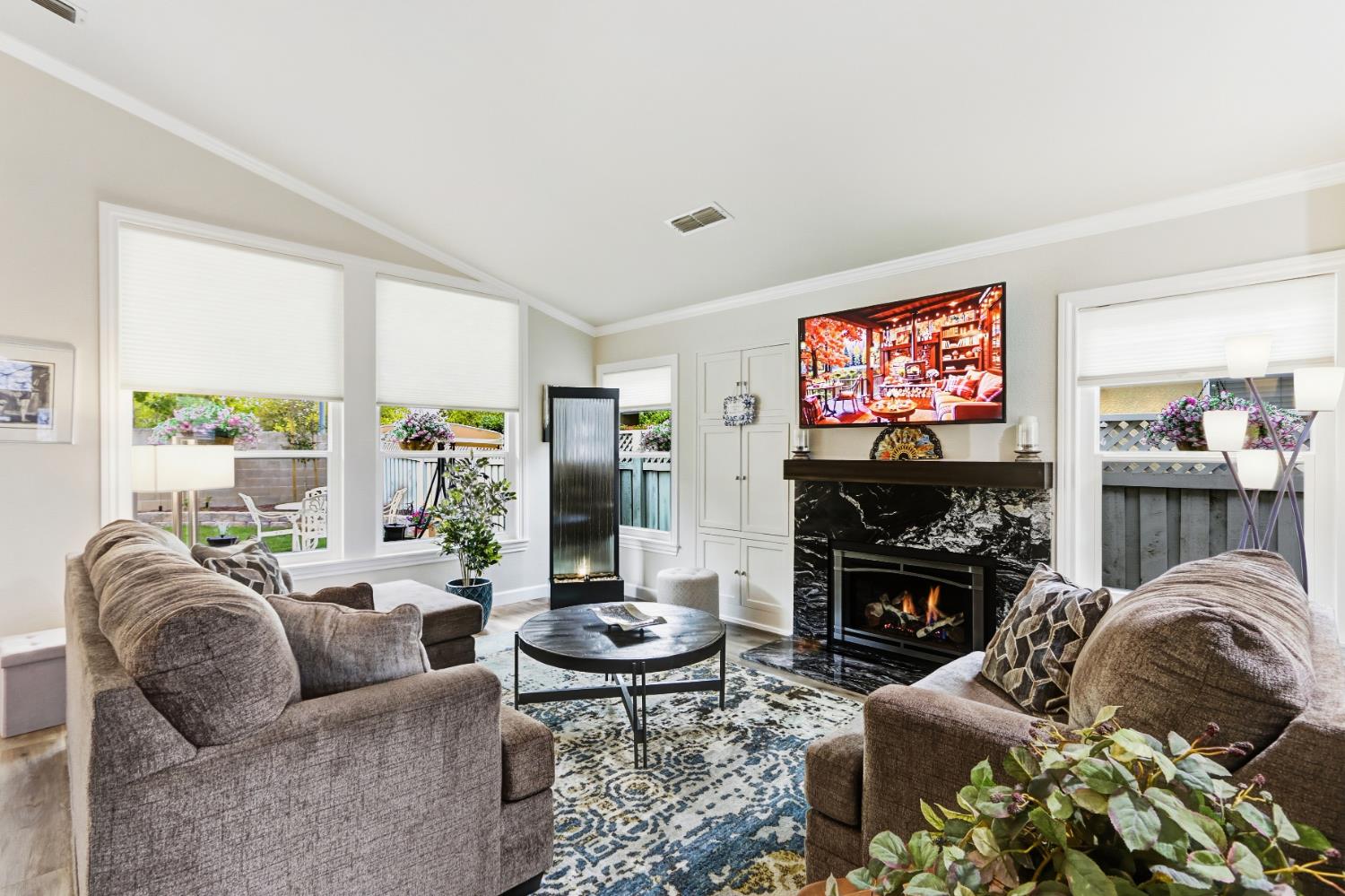 5297 Angelrock Loop Roseville, CA 95747 - Photo 6 of 33 a living room with fireplace furniture and a flat screen tv