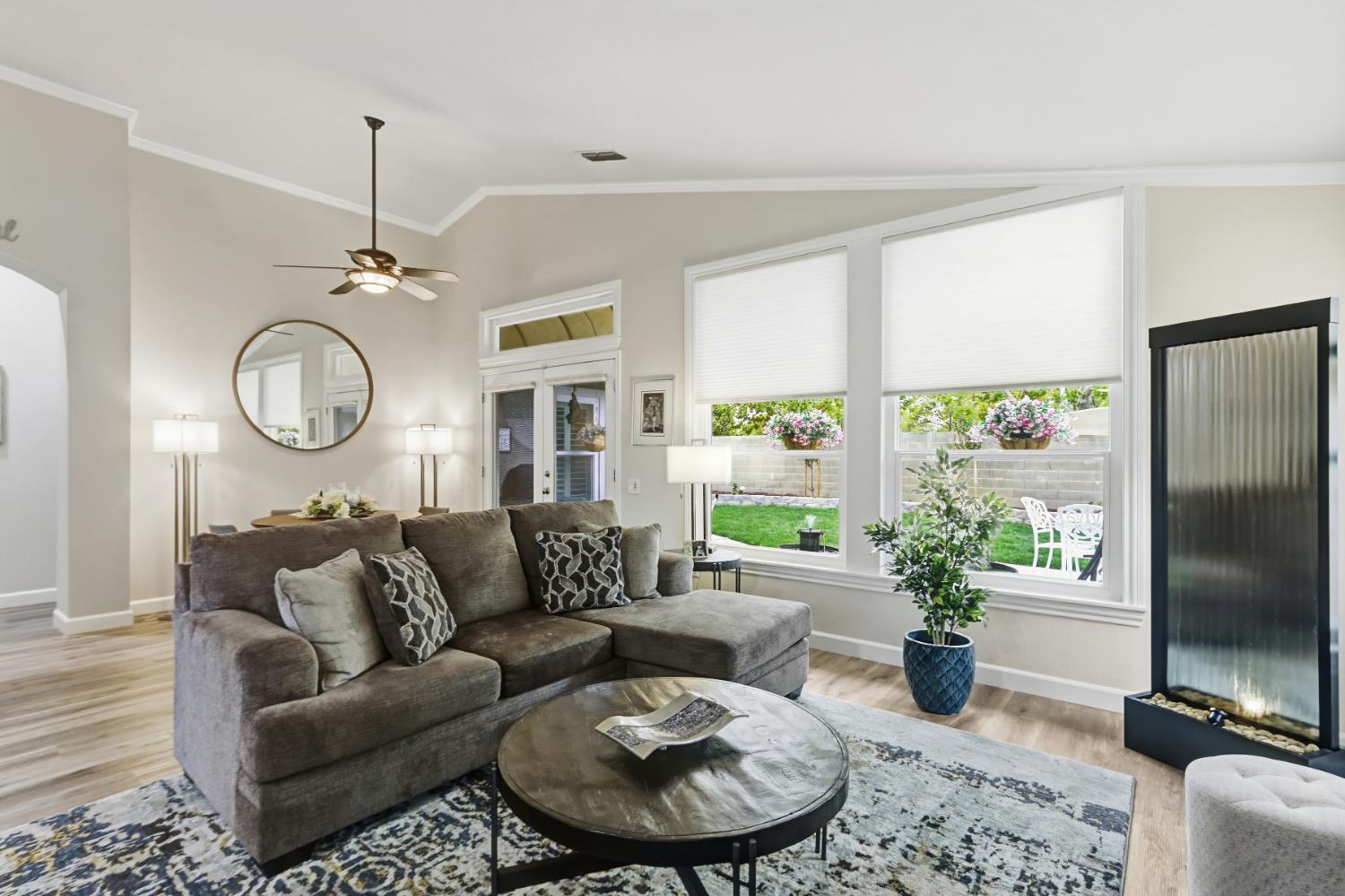 5297 Angelrock Loop Roseville, CA 95747 - Photo 8 of 33 a living room with furniture a large window and a clock