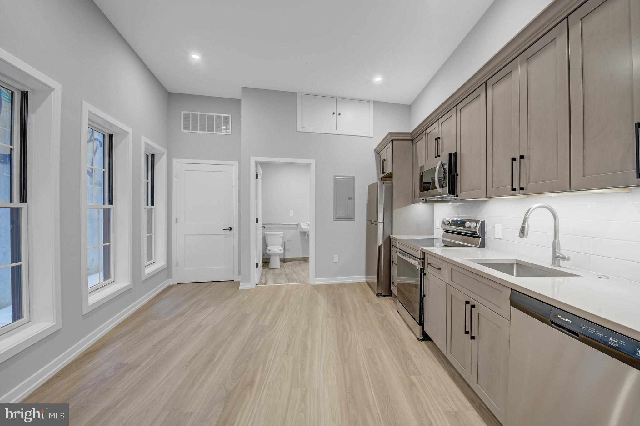 2445 Innovator Way, Unit 1A Philadelphia, PA 19146 - Photo 12 of 14 a large kitchen with stainless steel appliances granite countertop a lot of counter space and wooden floors