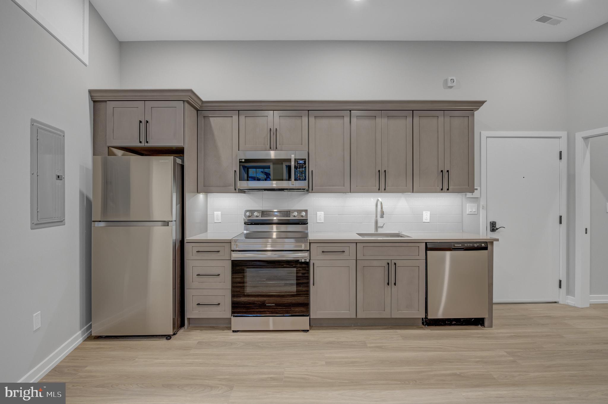 2445 Innovator Way, Unit 1A Philadelphia, PA 19146 - Photo 2 of 14 a kitchen with stainless steel appliances granite countertop a refrigerator a stove a sink and white cabinets